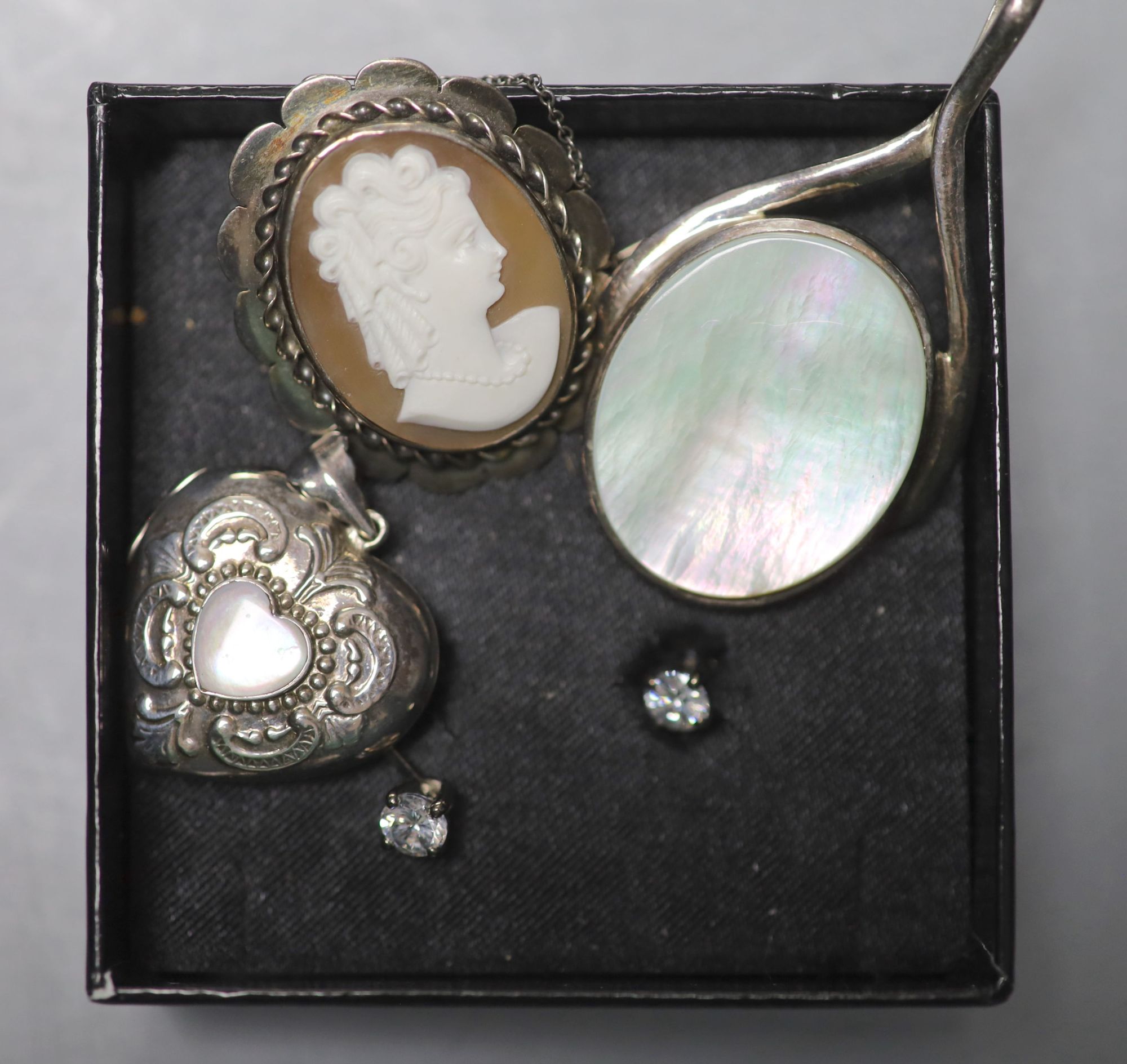 A silver locket, silver chains, a cameo brooch and a group of assorted costume jewellery.